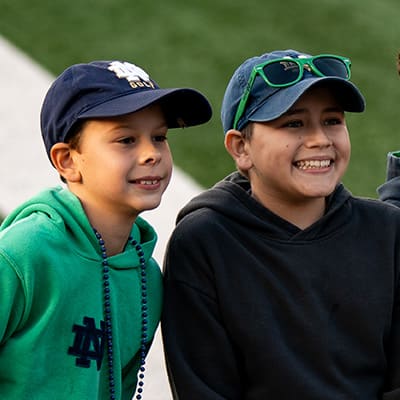 Two young boys smiling in Notre Dame gear