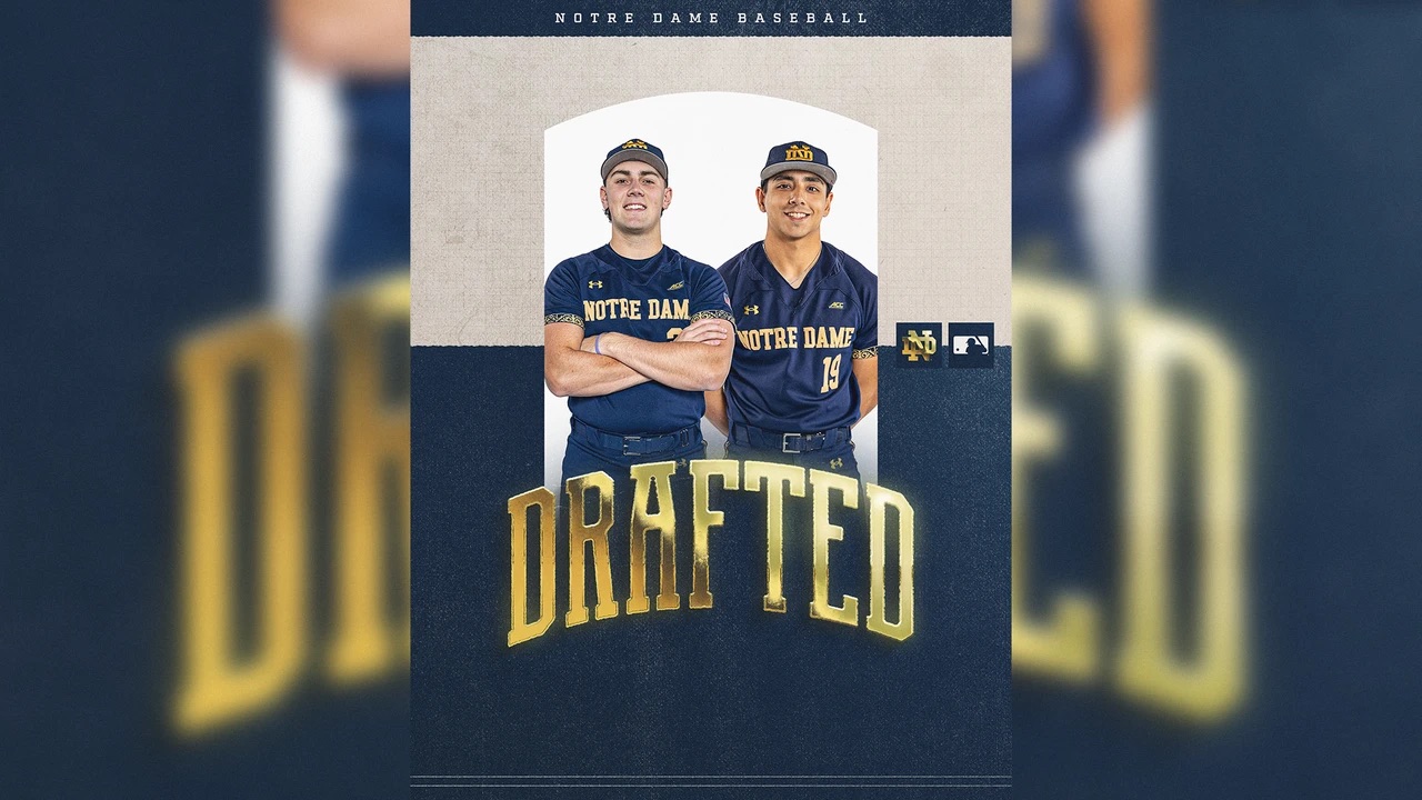 Two Notre Dame baseball players pose in navy blue team uniforms in a celebratory graphic announcing they were drafted into Major League Baseball. The image includes Notre Dame and MLB logos and features the word "DRAFTED" in large gold letters.