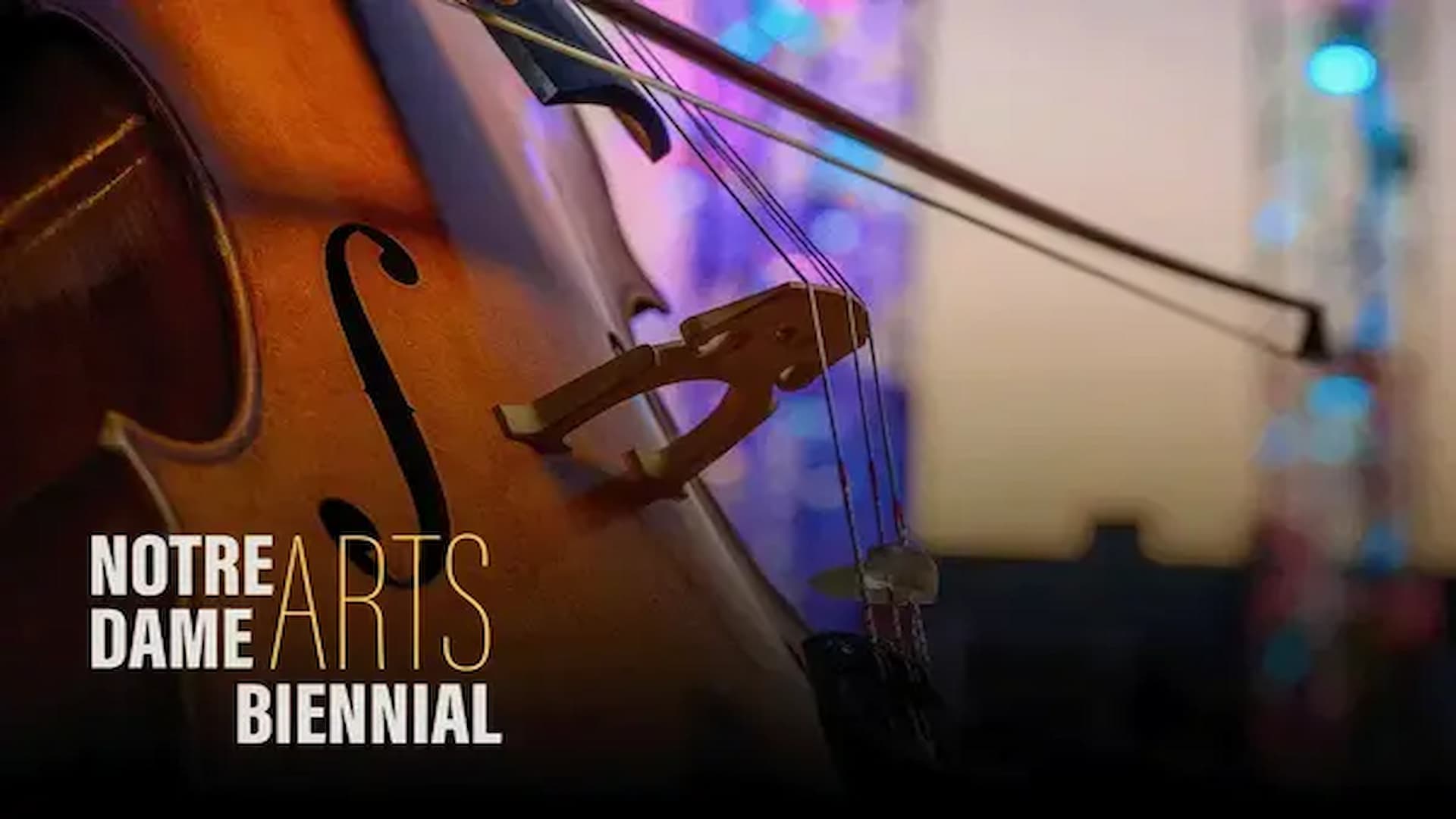 A close-up of a cello bow and strings with blurred sparkling lights in the background and text that reads "Notre Dame Arts Biennial"